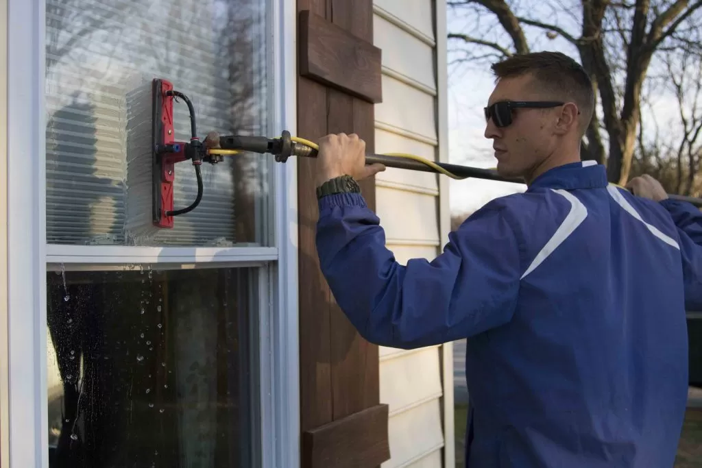 Man cleaning window, Residential Window Cleaning Services in Maryland