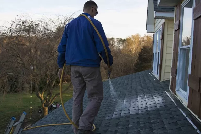 Man on roof cleaning, Residential Roof Cleaning - Residential Roof Washing in Maryland