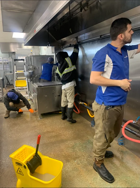 Maryland crew working on commercial hood cleaning in a kitchen, ensuring a sanitized environment with safe airflow.